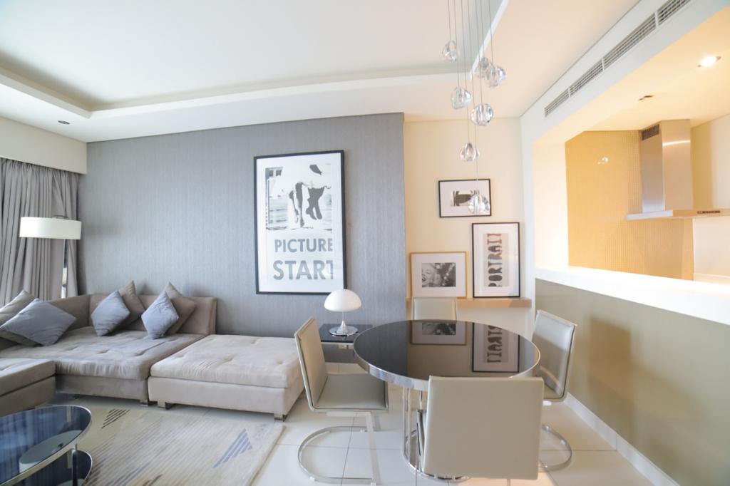 Living and dining area of a managed one-bedroom apartment at Paramount, Business Bay
