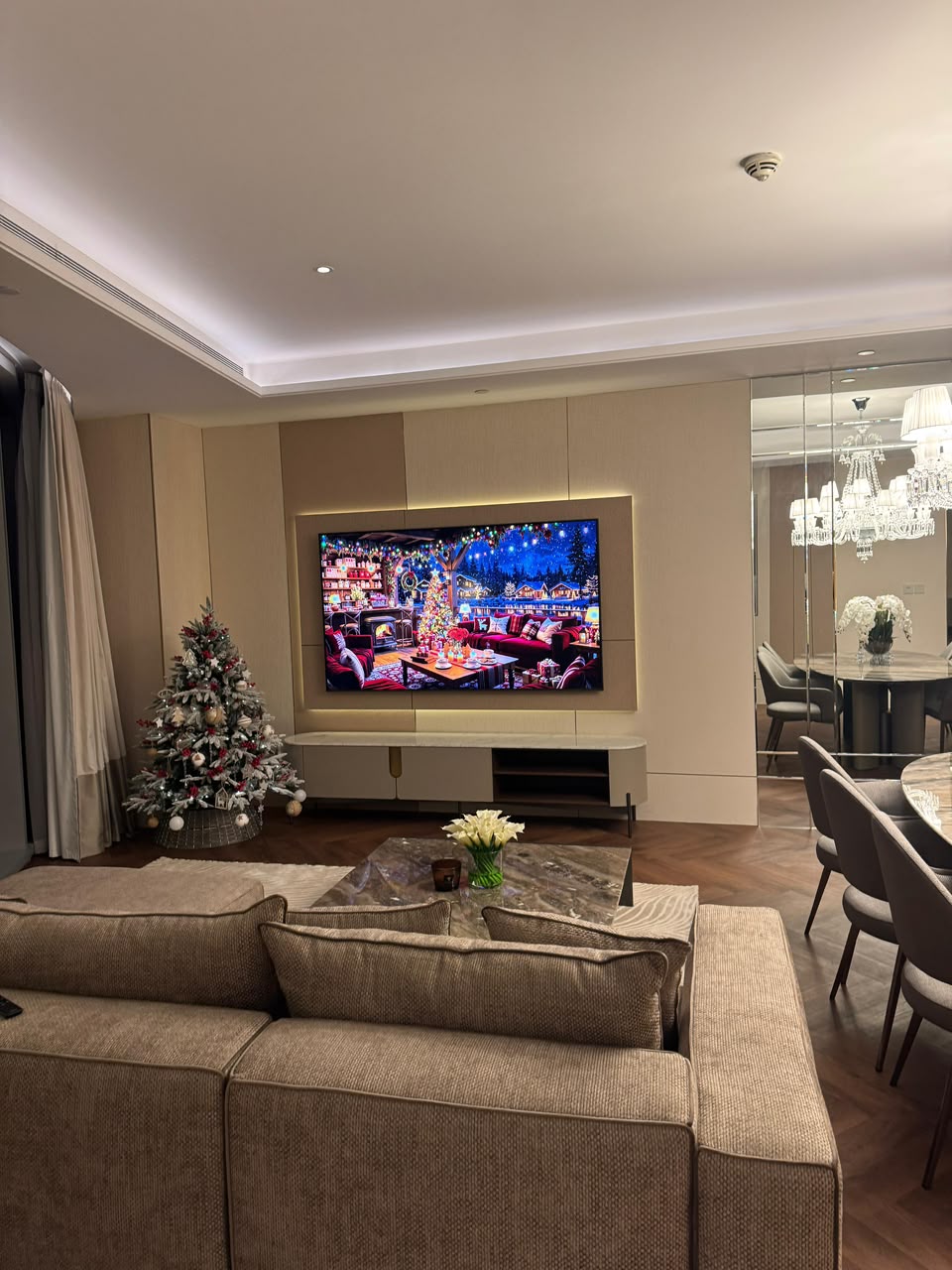 Living area at Address Sky View after renovation, with upholstered panelling and herringbone flooring